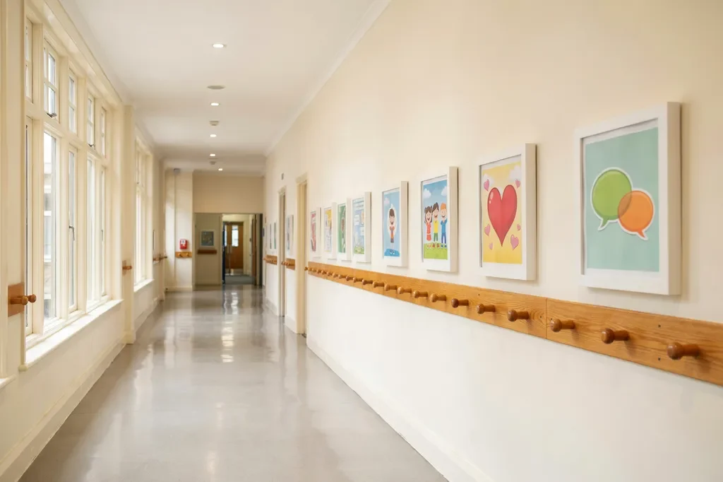 School corridor with colourful anti-bullying and kindness posters displayed at child eye level